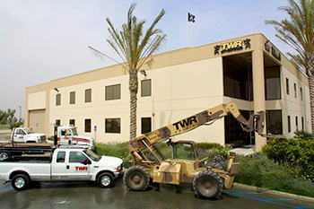 TWR current building with truck and machinery parked on front